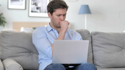 Sick Handsome Young Man Coughing while Working on Laptop at Creative Office