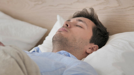 Fototapeta na wymiar Handsome Young Man Sleeping in Bed