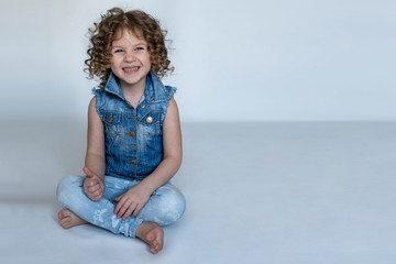 portrait of a beautiful, curly-haired girl who smiles