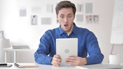 Casual Adult Man in Shock while Using Tablet