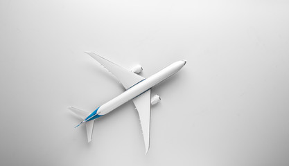 Travel concept with airplane toy over white background. Top view flat lay with copy space