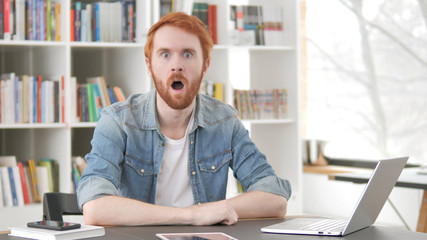 Young Casual Redhead Man in Shock Looking at Camera