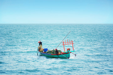 Fototapeta premium Fishermen catch fish in cloudy weather