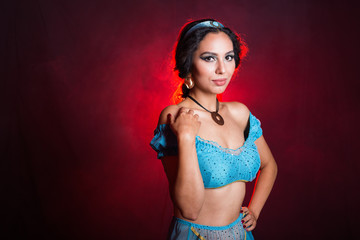 Portrait of princess Jasmine, a young woman in the image of an Eastern fairy Princess on dark background. © satura_