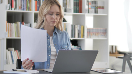 Young Blonde Woman Working on Documents and Laptop, Paperwork