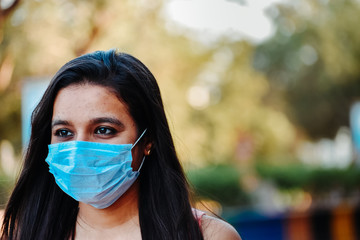 Portrait of an Indian female wearing medical mask to prevent herself from the Corona Virus Pandemic