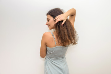 Naklejka premium Fashion woman in elegant dress touching her hair. Sensual portrait of attractive woman