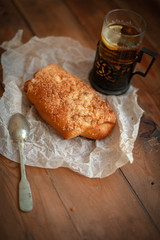 Freshly baked appetizing bun and tea on the board