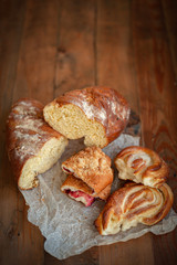 Freshly baked appetizing bun and bread on the board