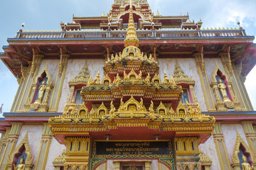 Naklejka premium Buddhist temple with Buddha statues on a green background.
