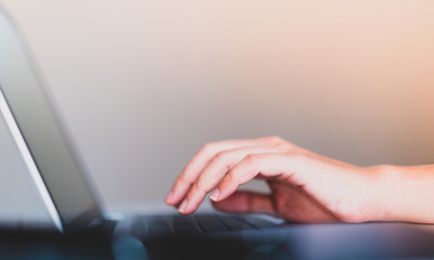 hand on laptop keyboard with clean background, work at home concept