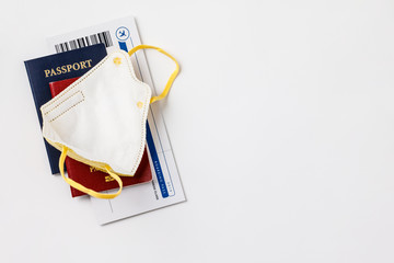 Coronavirus and travel concept. Passports, airplane tickets and medical mask flat lay.