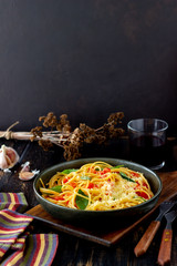 Pasta spaghetti with tomatoes, basil and parmesan cheese. Italian cuisine. Recipe. Vegetarian food. Healthy eating.
