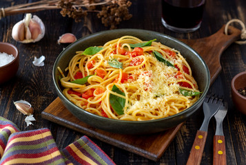Pasta spaghetti with tomatoes, basil and parmesan cheese. Italian cuisine. Recipe. Vegetarian food. Healthy eating.