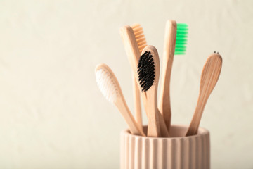 Tooth brushes in holder on light background