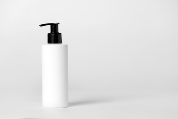 Bottle of shampoo on light background