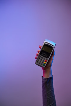 Hand with pin-pad. Payment via pos terminal.