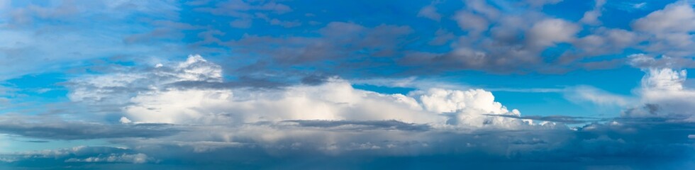 Fantastic clouds against blue sky, panorama