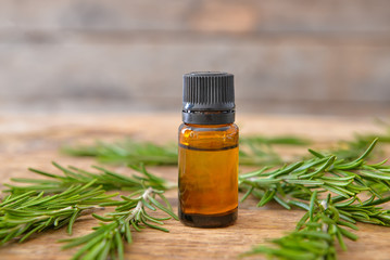 Bottle of rosemary essential oil on table