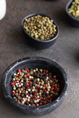 Mix of different pepper black ,white, pink ,green and allspice peppercorns in marble bowl. Aromatic herb and Spicy Seasoning for cooking concept.