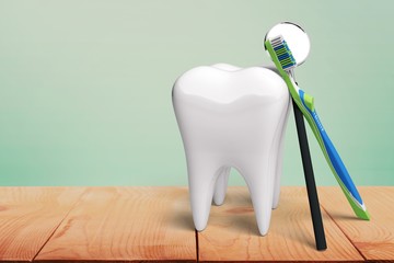Human's white tooth and dentist mirror and toothbrush