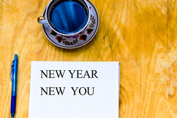 Cup of coffe and open notebook on wooden background