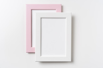 top view of two pink and white wood photo frame