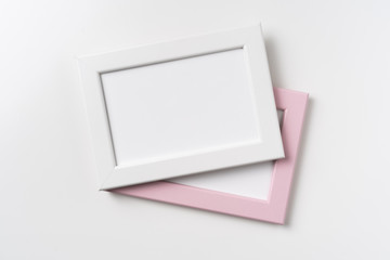 top view of two pink and white wood photo frame