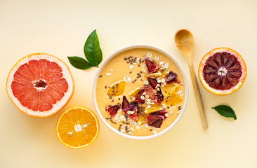Fototapeta na wymiar Citrus smoothie bowl with grapefruit and orange on a light background