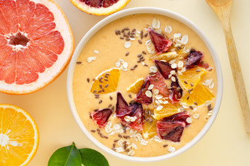 Citrus smoothie bowl with grapefruit and orange on a light background