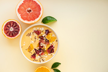 Citrus smoothie bowl with grapefruit and orange on a light background
