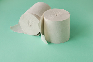 Two rolls of toilet paper on a colored background