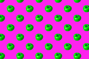 Creative food pattern – green tomatoes on pink background. Toxic vegetables concept. Minimal abstract design