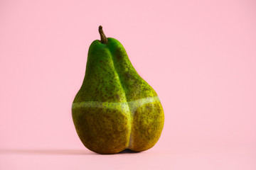 dark overexposed pear with traces of sunburn, creative concept summer vacation sunburn