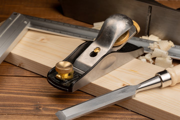 Chisel and small block plane with wood shavings
