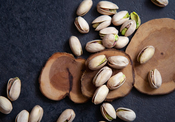 Roasted pistachios nuts on dark background. Healthy snack