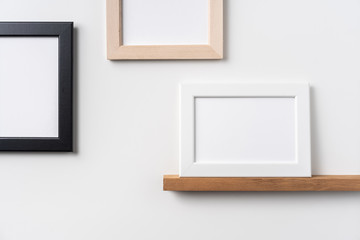 black and white wood photo on bookshelf and wall