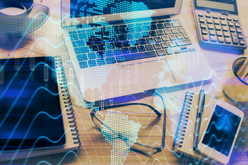 Financial graph colorful drawing and table with computer on background. Double exposure. Concept of international markets.