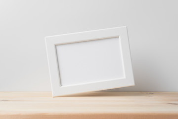 horizontal white wood photo on floor with white wall