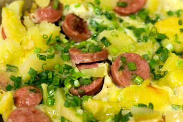 Fried potatoes with meat, egg and fresh onions