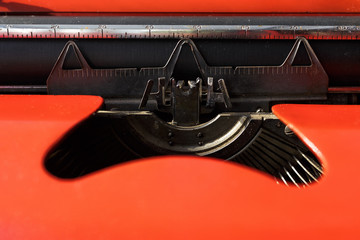 details of a typewriter mechanism in saturated red