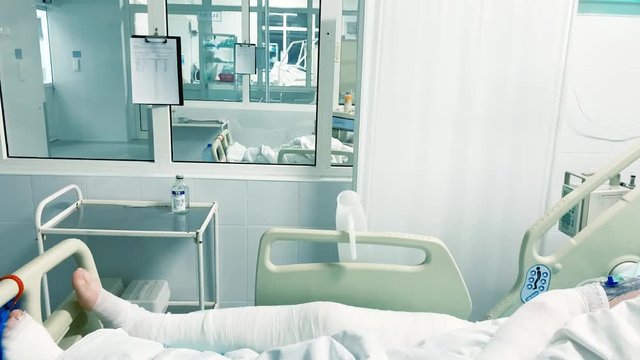 Damaged patient with skin burn disease in hospital intensive care unit room. man get hard burning injury, large flame or thermal burn