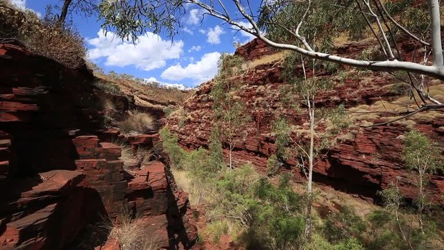 Beautiful scenic footage isolated area of Hancock Gorge  red rock mountain formation trees valley outback, in Karijini national park, Perth, Australia