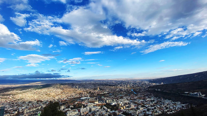 Beautiful aerial view of the central part of city  and blue sky in Tbilisi, Georgia © Victoria Key