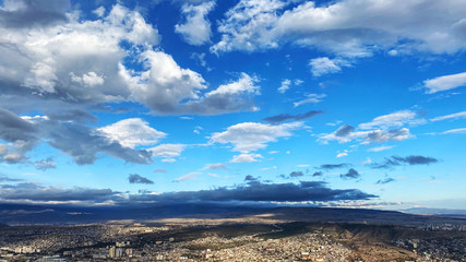 Beautiful aerial view of the central part of city  and blue sky in Tbilisi, Georgia © Victoria Key