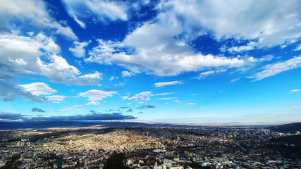 Beautiful aerial view of the central part of city  and blue sky in Tbilisi, Georgia © Victoria Key