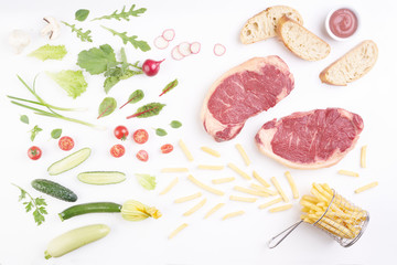 steak on white background with vegetables