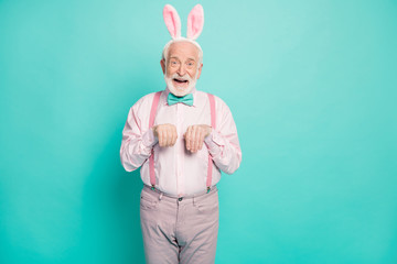Portrait of amazed excited old man enjoy easter event party imagine he funny funky rabbit fooling...