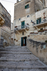 Obraz premium Cobblestone street in the Sassi di Matera a historic district in the city of Matera. Basilicata. Italy