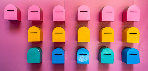 Red, yellow and blue postbox mailboxes